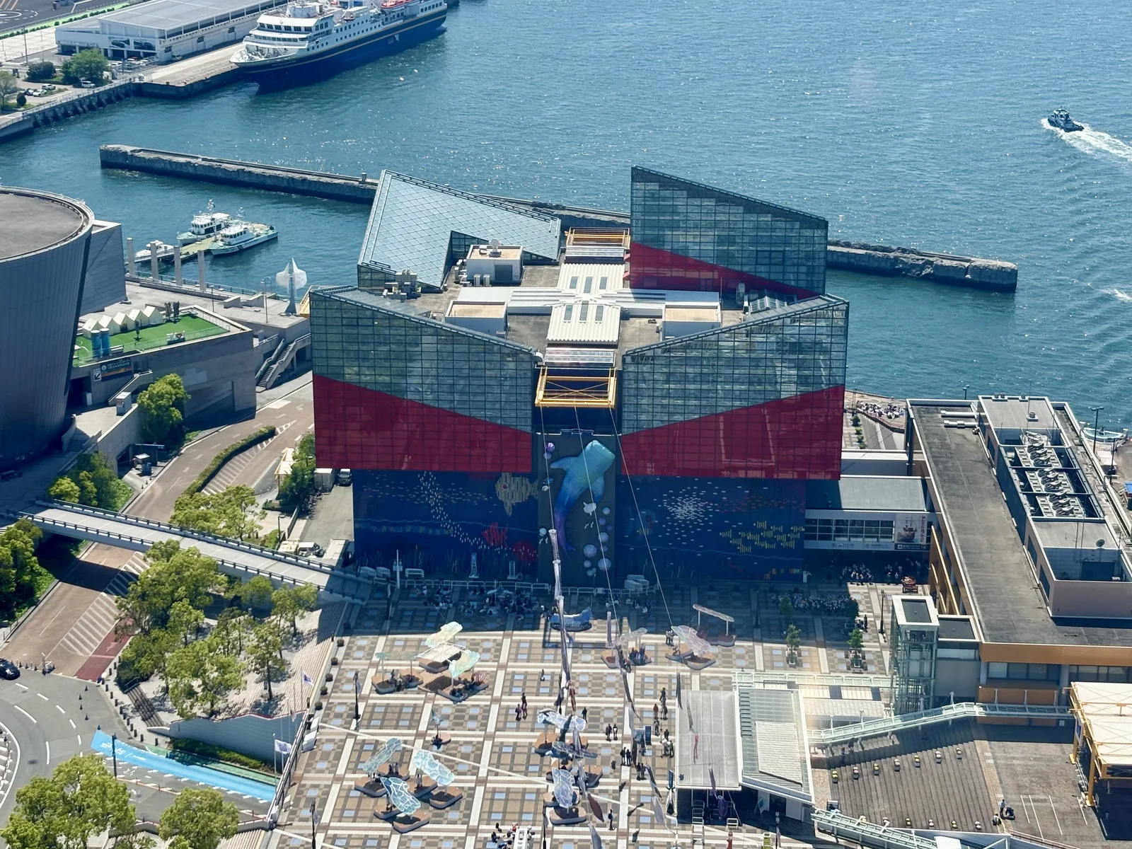 Osaka Aquarium Kaiyukan's blue and red exterior beside Osaka Bay at Tempozan